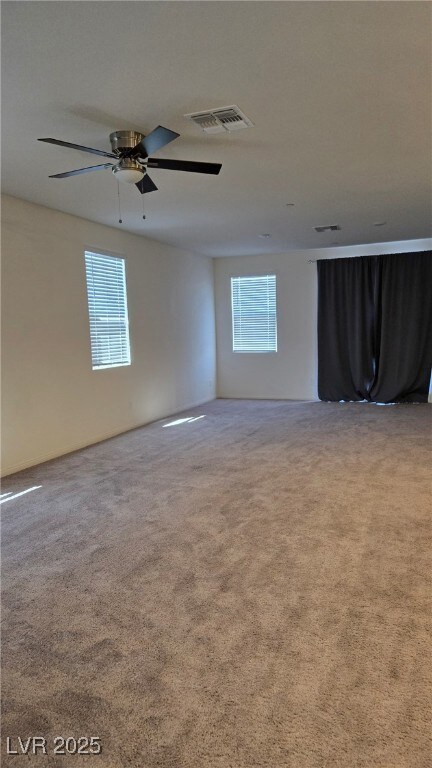 Spare room with plenty of natural light, carpet fl