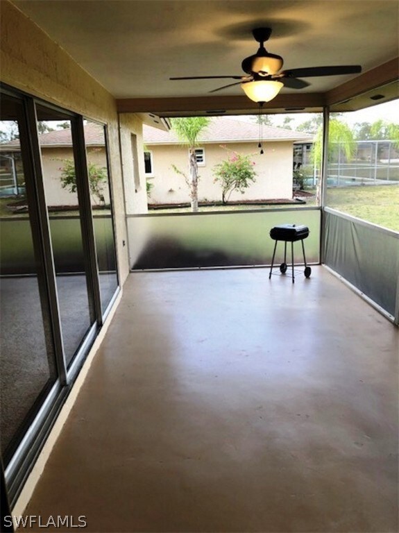 Large lanai with sliders to both the living room a