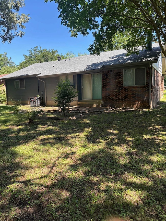 View of front facade featuring a front yard and brick siding