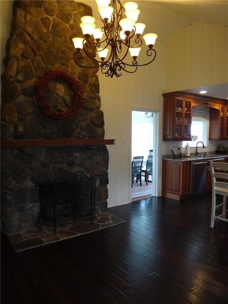 Stone fireplace in the living room with the entran