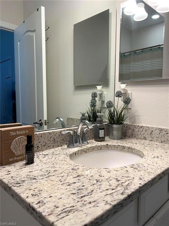 Baths with light granite, plank tile in showers
