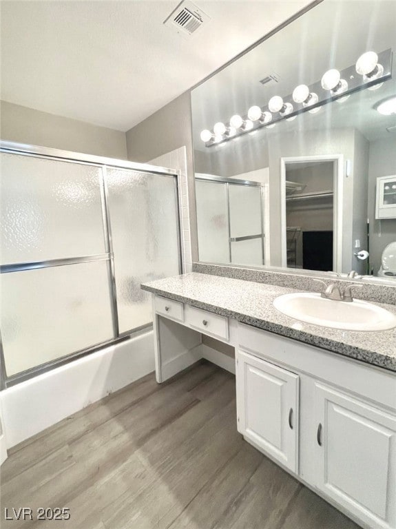 Bathroom with vanity, combined bath / shower with