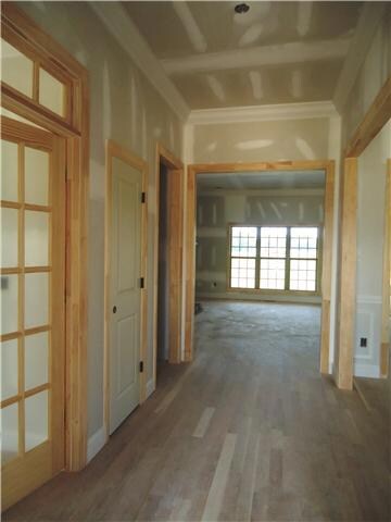Entry foyer has large dining room to the right, 4th bedroom with french transom doors, coat closet and powder room on the left.  