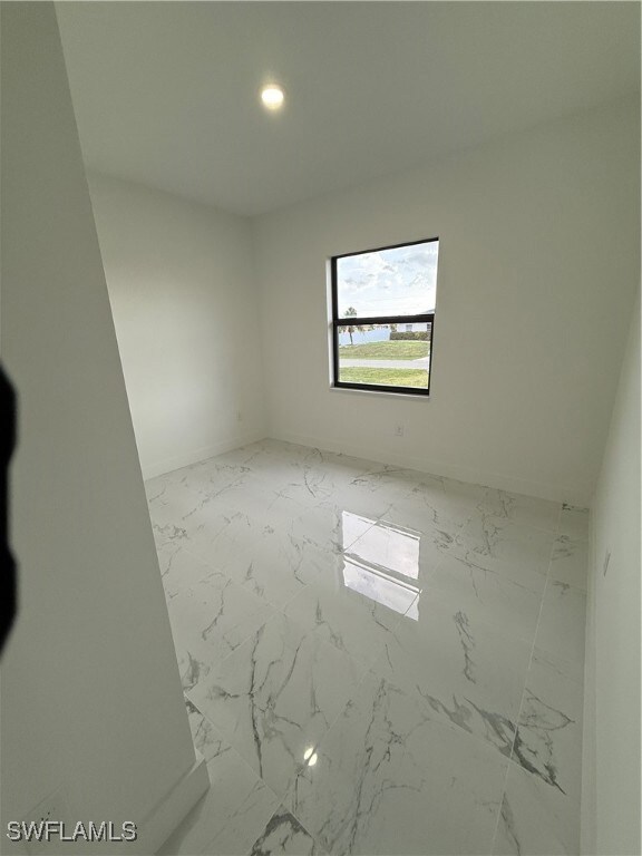 Empty room featuring marble finish flooring and re