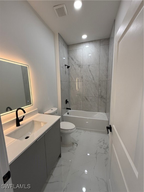 Full bathroom with marble finish floors, vanity, s