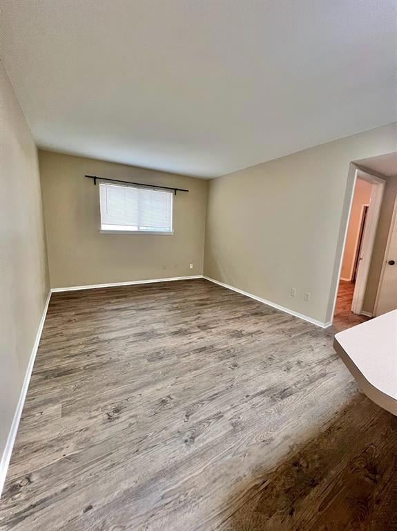 Empty room featuring wood finished floors and baseboards