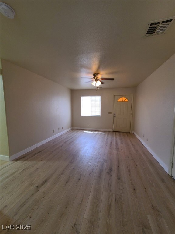 Unfurnished room featuring a ceiling fan and light