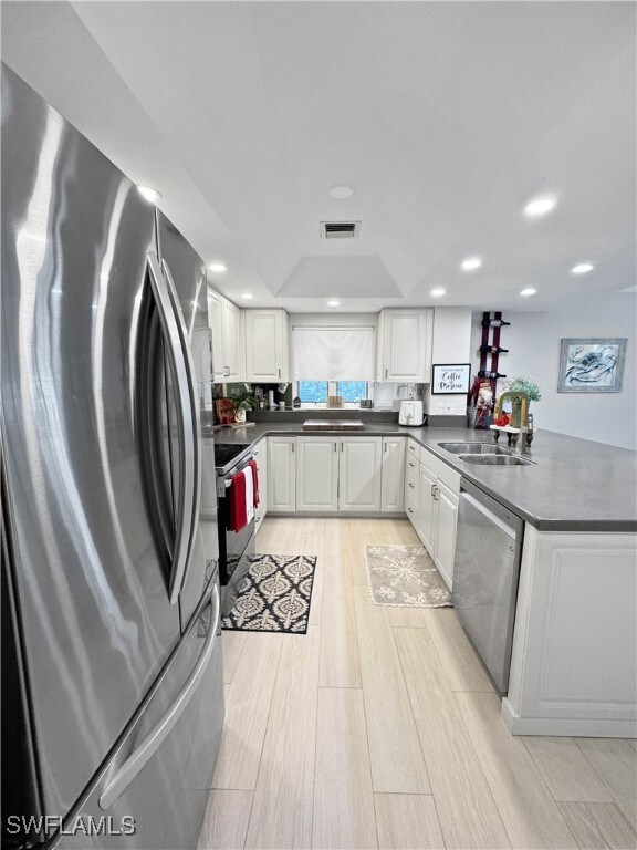 Kitchen featuring kitchen peninsula, appliances wi