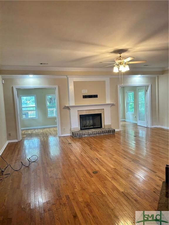 Grate room  fireplace with beautiful floors. Entry