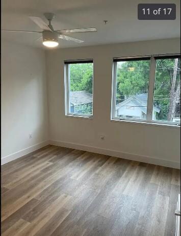 Empty room featuring baseboards, wood finished fl
