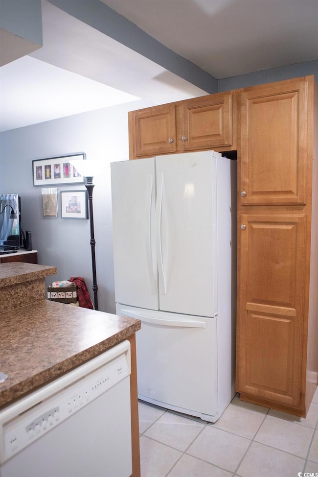 Kitchen featuring light tile patterned floors and 