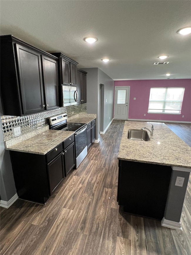 Kitchen with decorative backsplash, appliances wi