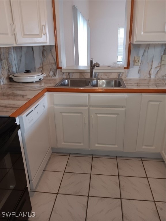 Kitchen featuring dishwasher, white cabinetry, and