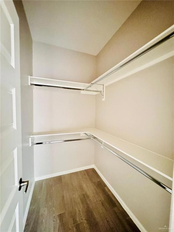 Spacious closet with wood finished floors