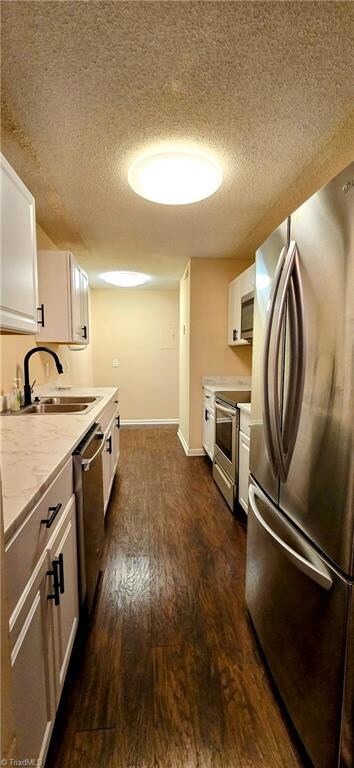 Bright kitchen with stainless appliances - refrigerator remains