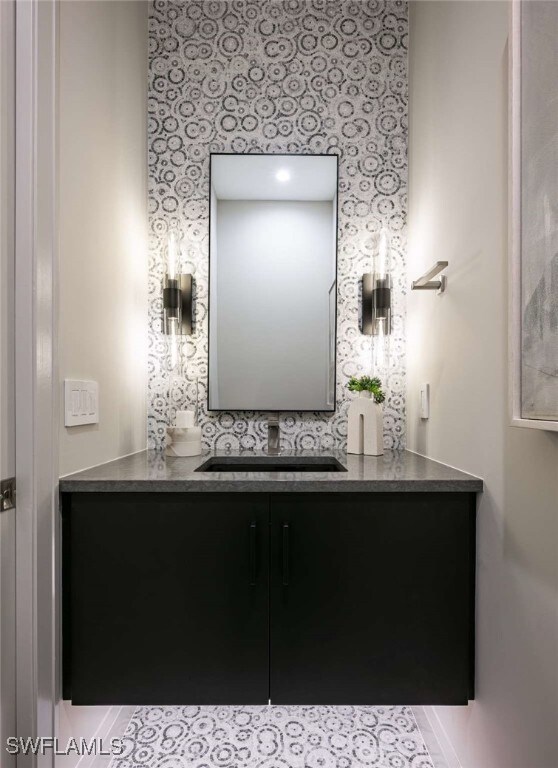 Bathroom featuring vanity and wallpapered walls