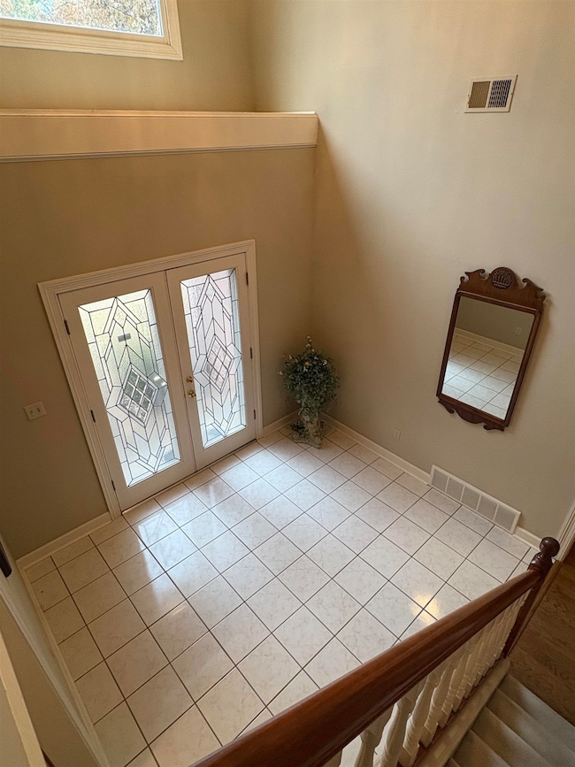 Foyer featuring french doors and light tile patter