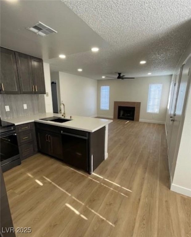 Kitchen with range with electric stovetop, light c