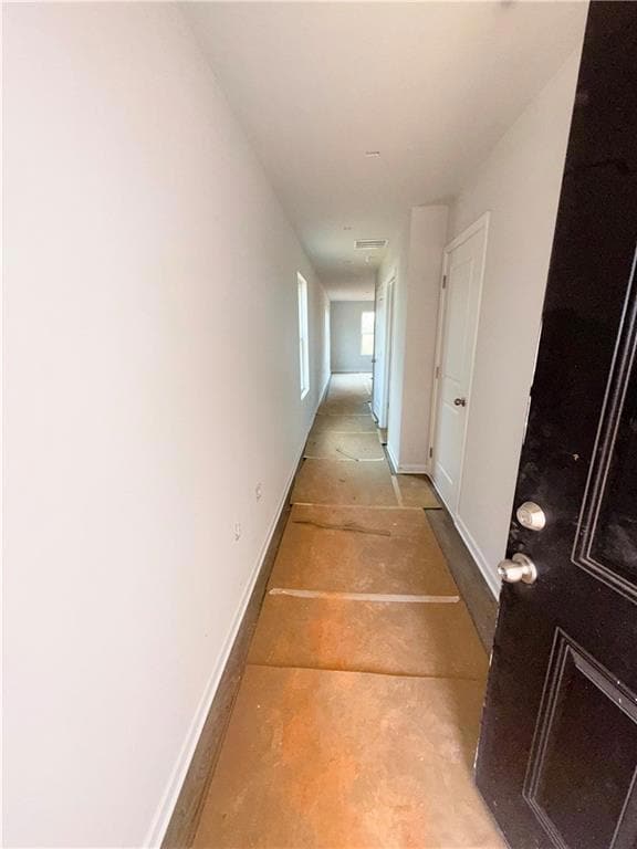Hallway featuring baseboards