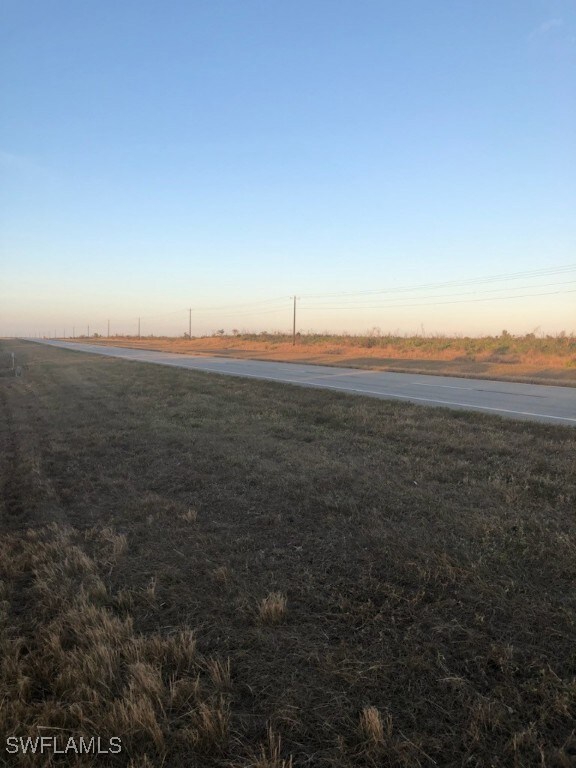 Yard at dusk featuring a rural view