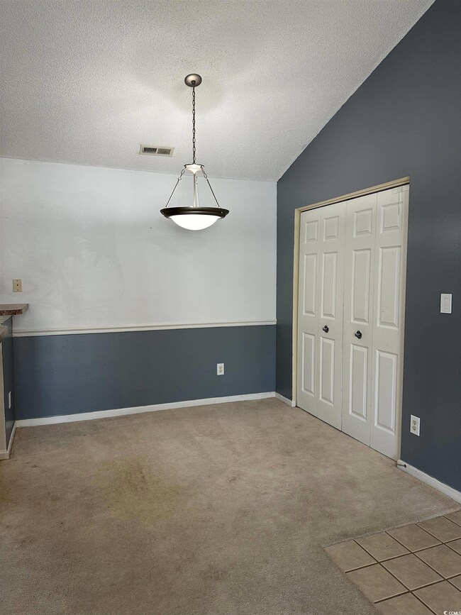 Unfurnished bedroom with a closet, carpet, lofted 