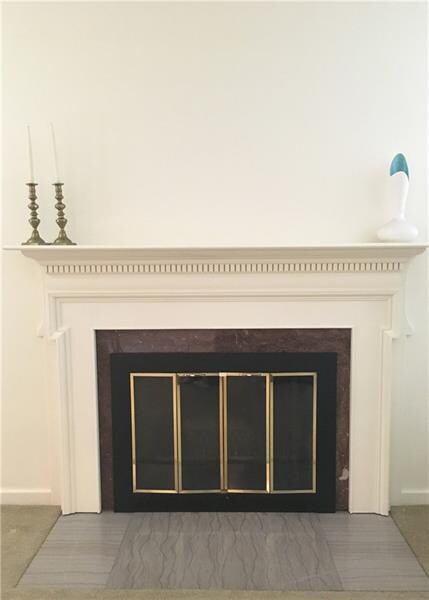 Beautiful fireplace is the focal point of this lar