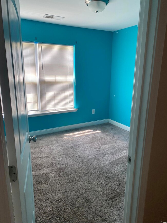 Empty room with carpet floors