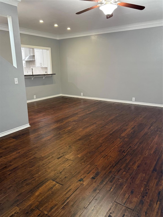 Unfurnished living room with ornamental molding, d