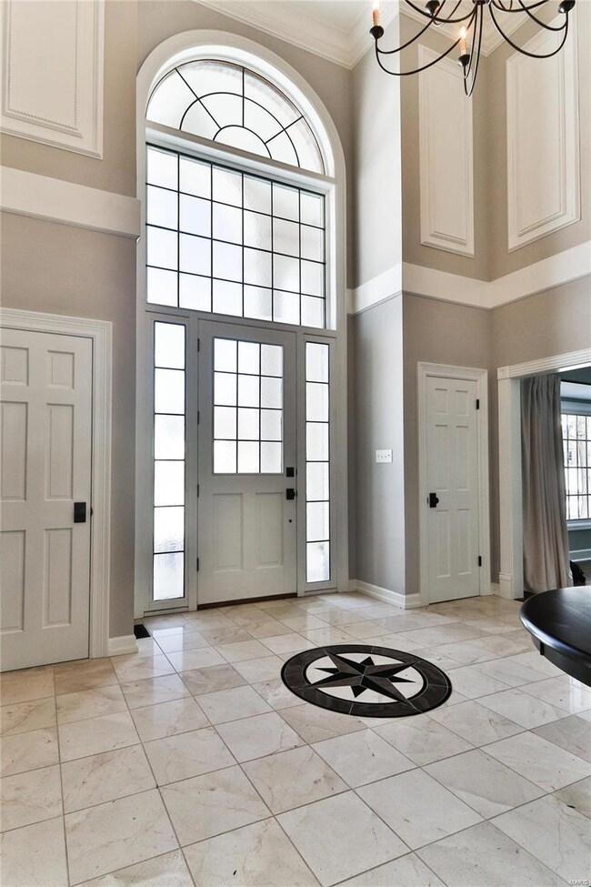 Impressive two story entry foyer with marble floors and palladium glass