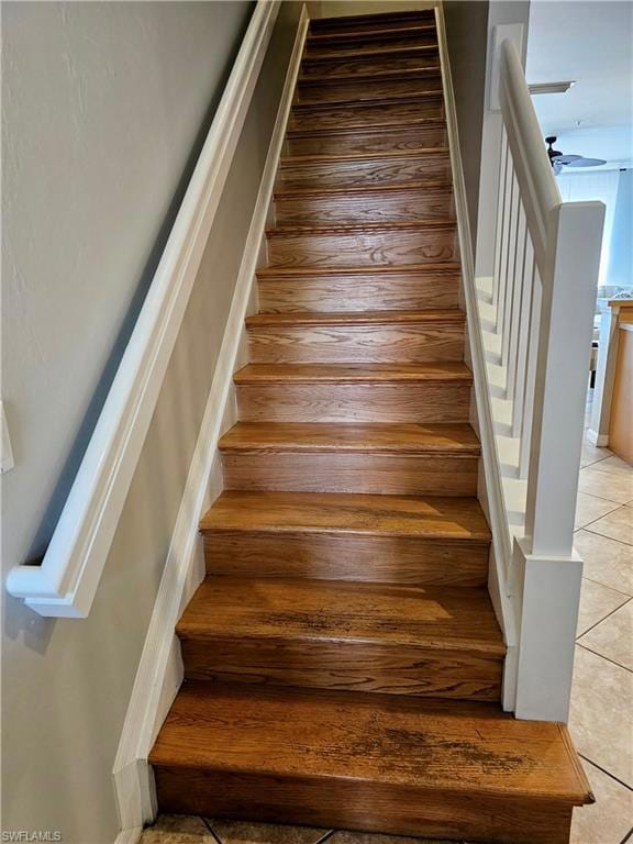 Stairs featuring tile patterned floors and a ceili