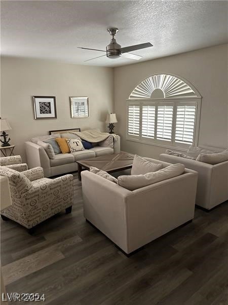 Living room with ceiling fan, dark wood-style floo