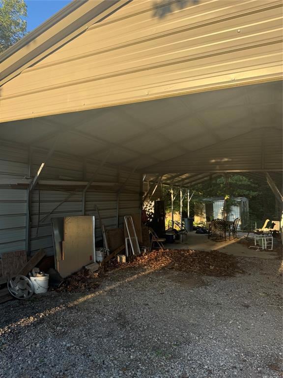 View of parking with a detached carport