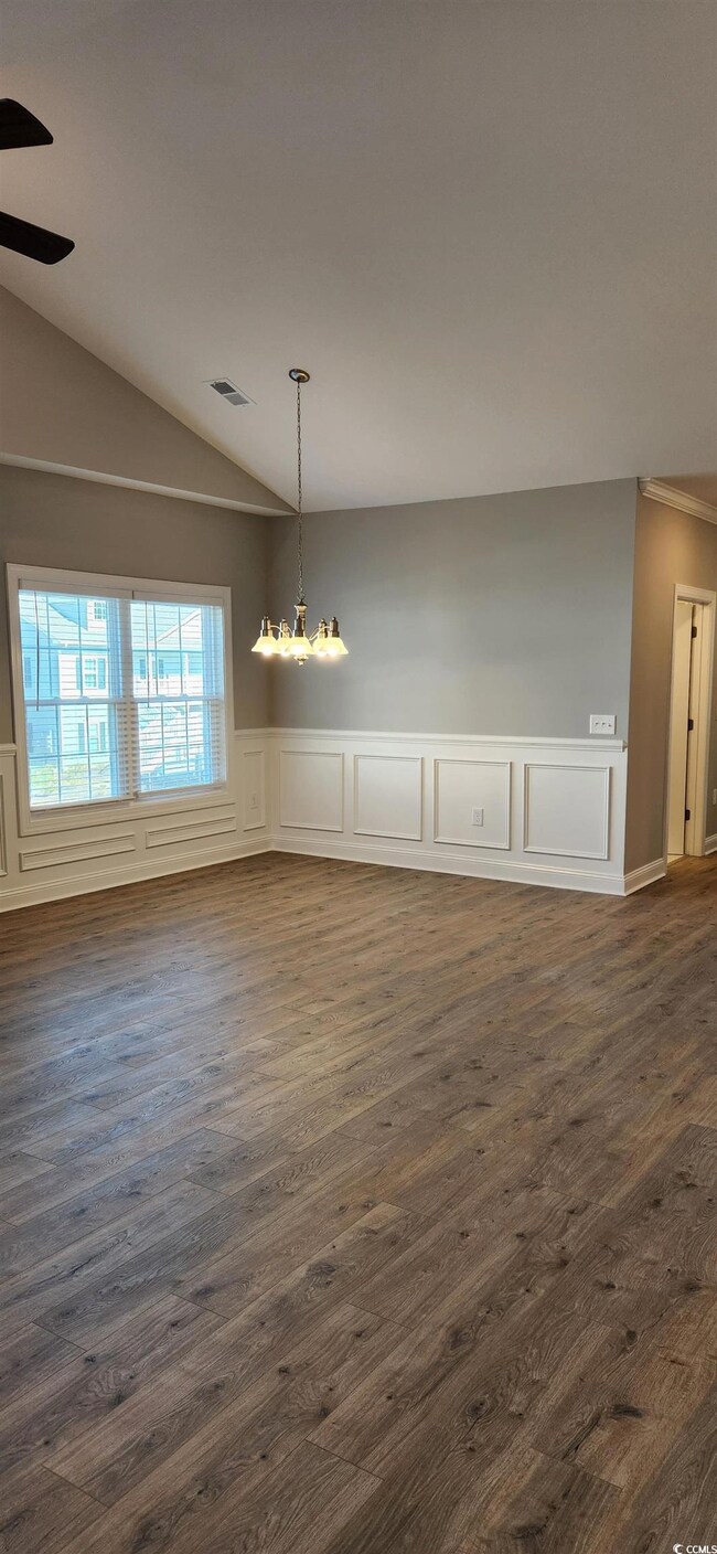 Unfurnished dining area with dark wood-type floori