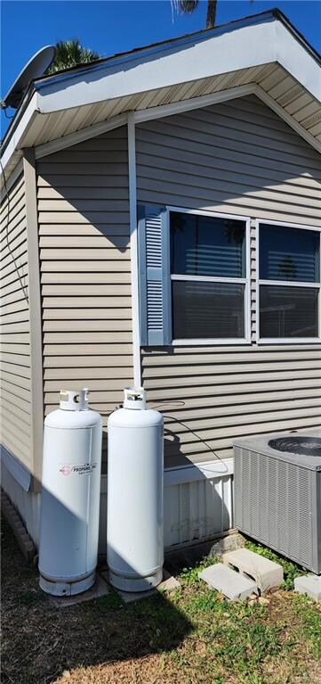 View of side of home with central AC unit