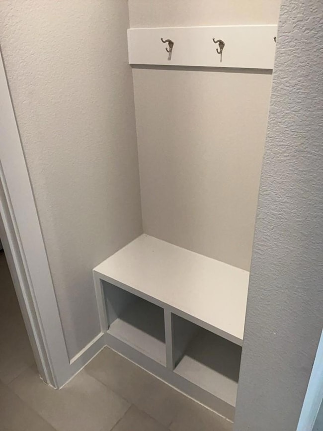 Mudroom featuring tile patterned floors and a tex