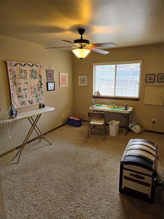 Bedroom/Playroom with ceiling fan and carpet
