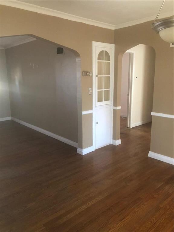 Arched doorway in dining room leading to hall.  Bu