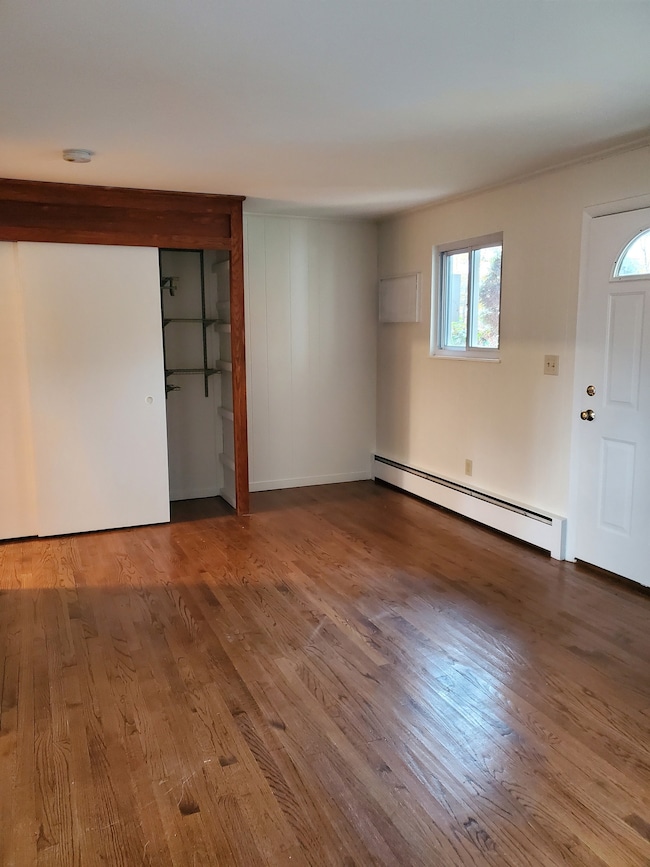 Living room has hardwood flooring and double closet.