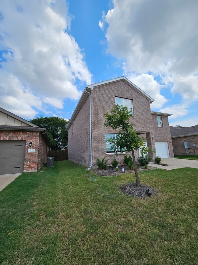Traditional home with brick siding and driveway