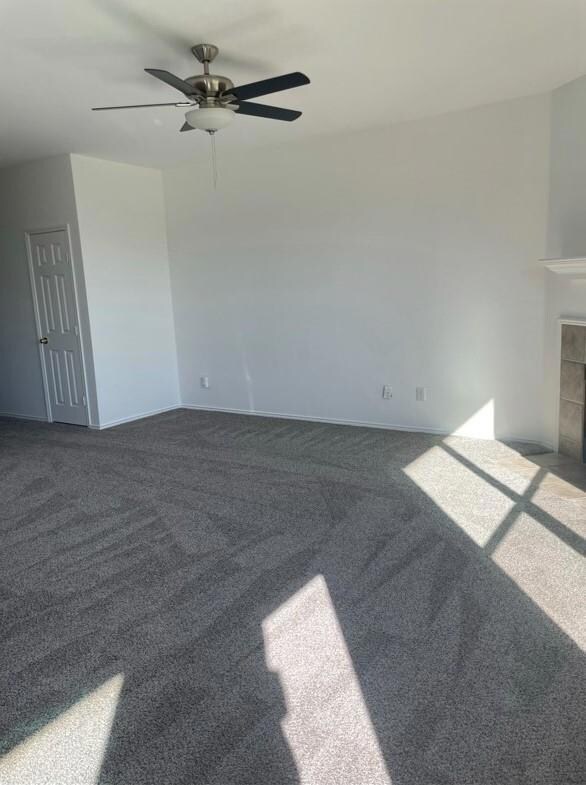 Unfurnished living room with carpet flooring, a ti
