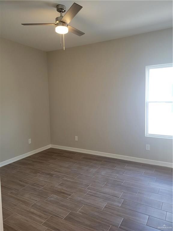 Spare room with ceiling fan