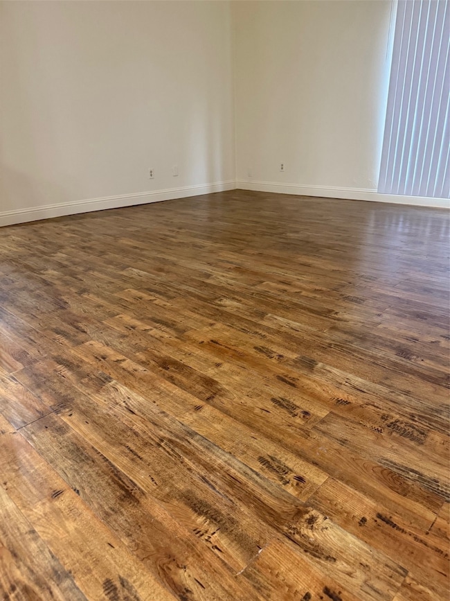 Master bedroomroom featuring dark wood-type flooring and baseboards
