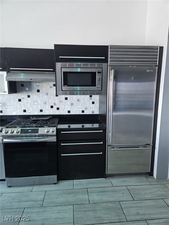 Kitchen featuring built in appliances, extractor f