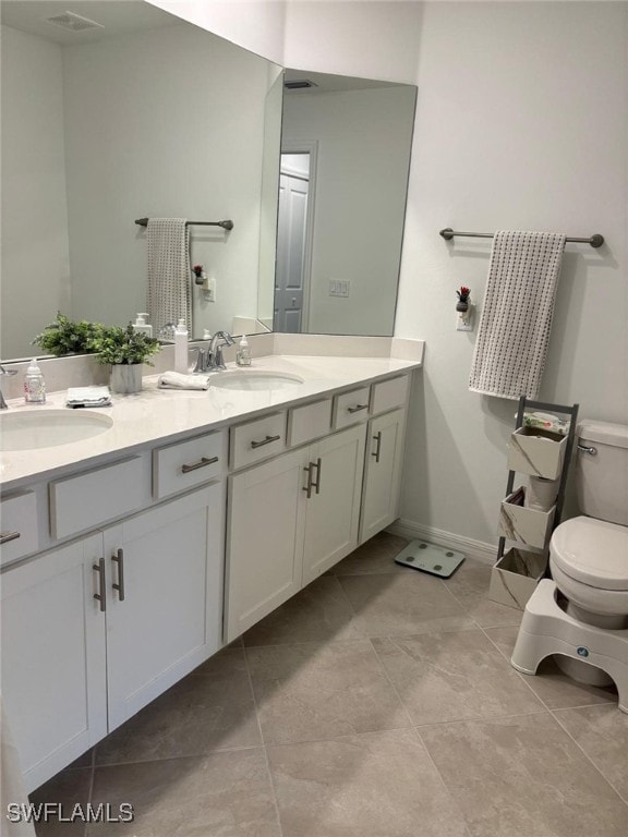 Bathroom with double vanity and light tile patterned floors