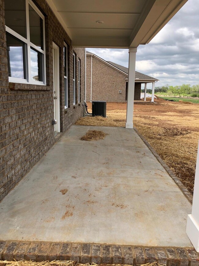 Covered back patio looks out to deepest homesite in Valleybrook and tree-line