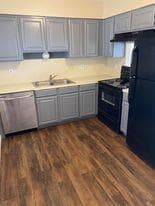 Kitchen with light countertops, gray cabinetry, a