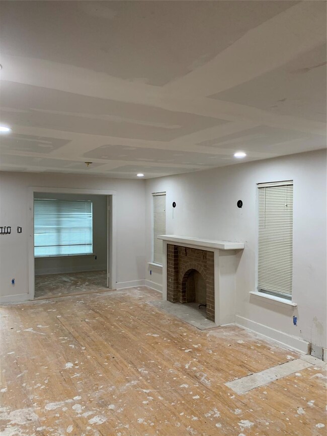 View of decorative fireplace and recessed lights.