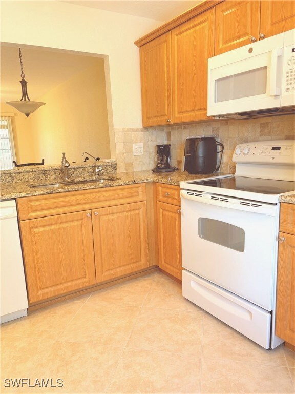 Kitchen featuring sink, tasteful backsplash, light