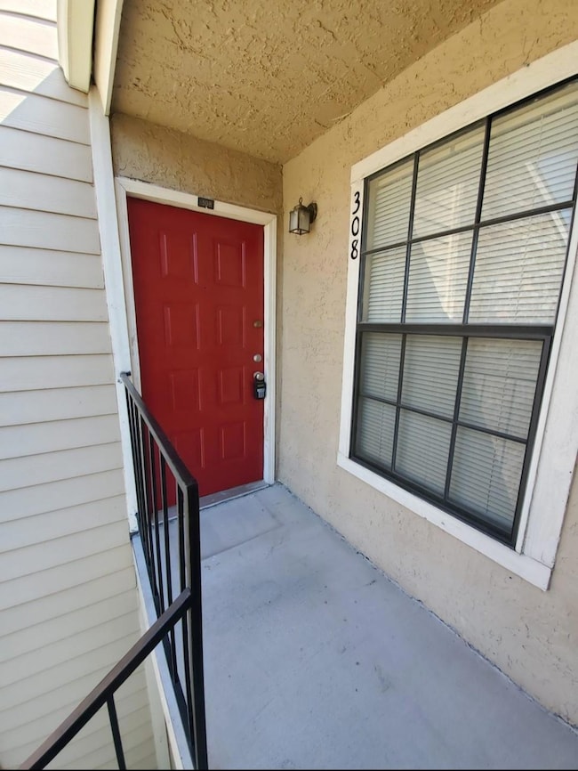 Doorway to property featuring stucco siding