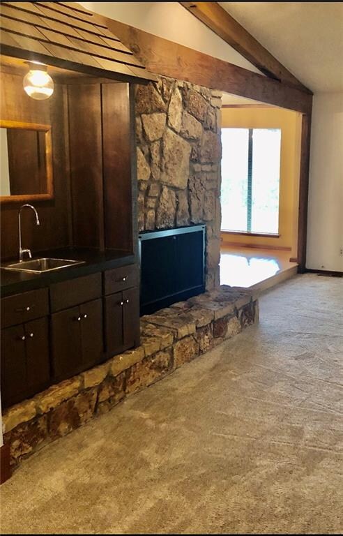 A closer shot of the fireplace and wet bar.